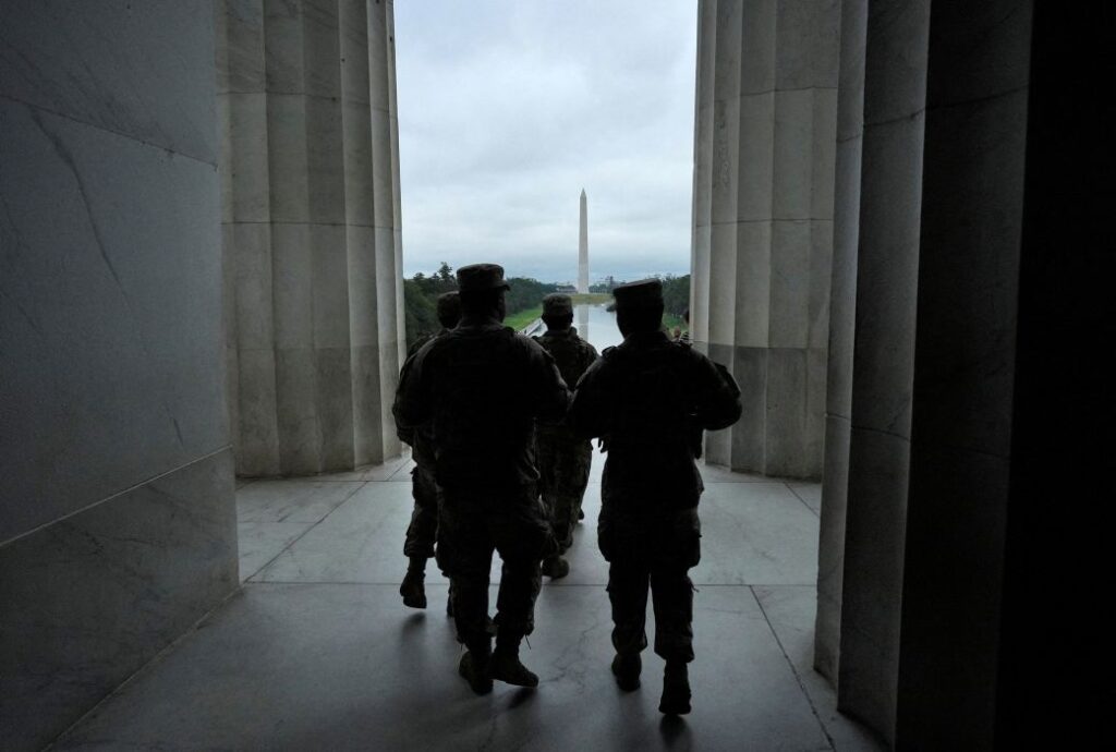 Members of the National Guard walk inside the Lincoln Memorial in Washington, DC