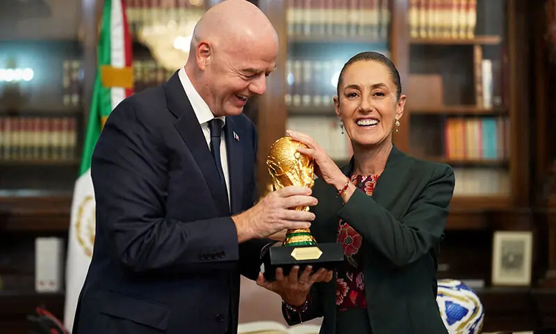 Mexican President Claudia Sheinbaum and FIFA president Gianni Infantino hold the FIFA World Cup trophy at the National Palace, in Mexico City, Mexico