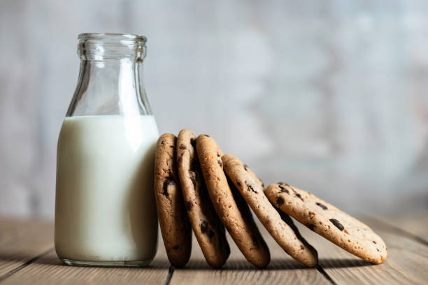 chocolate cookies with a bottle of milk on table.