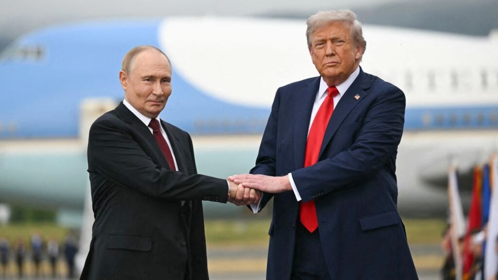 US President Donald Trump shakes hands with Russian President Vladimir Putin
